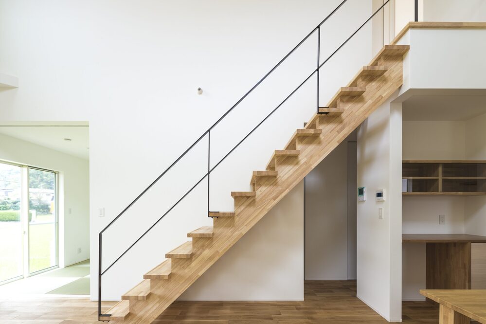 光が降りる吹き抜けとオープンな階段の家